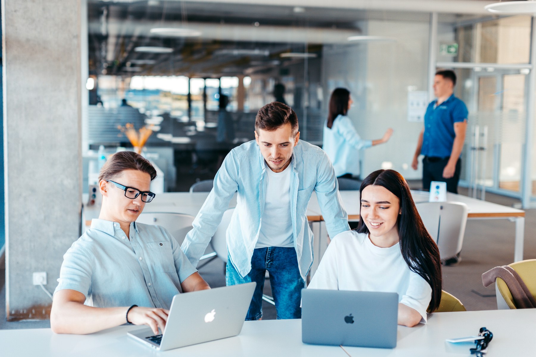 Team working together at laptops in an open-plan office